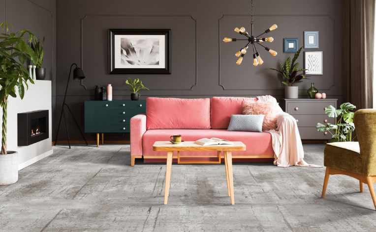 gray patterned carpet in eclectic living room with pink couch